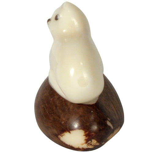 Hand-carved kitty cat figurine made from tagua nuts, showcasing natural colors and intricate details, symbolizing sustainable craftsmanship.