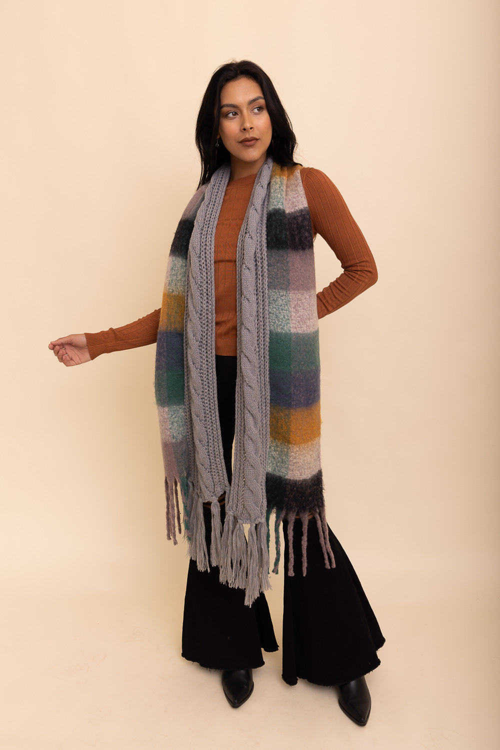 A stylish knit blend scarf with tassel trim, perfect for cold weather outfits, showcasing its soft texture and trendy design.