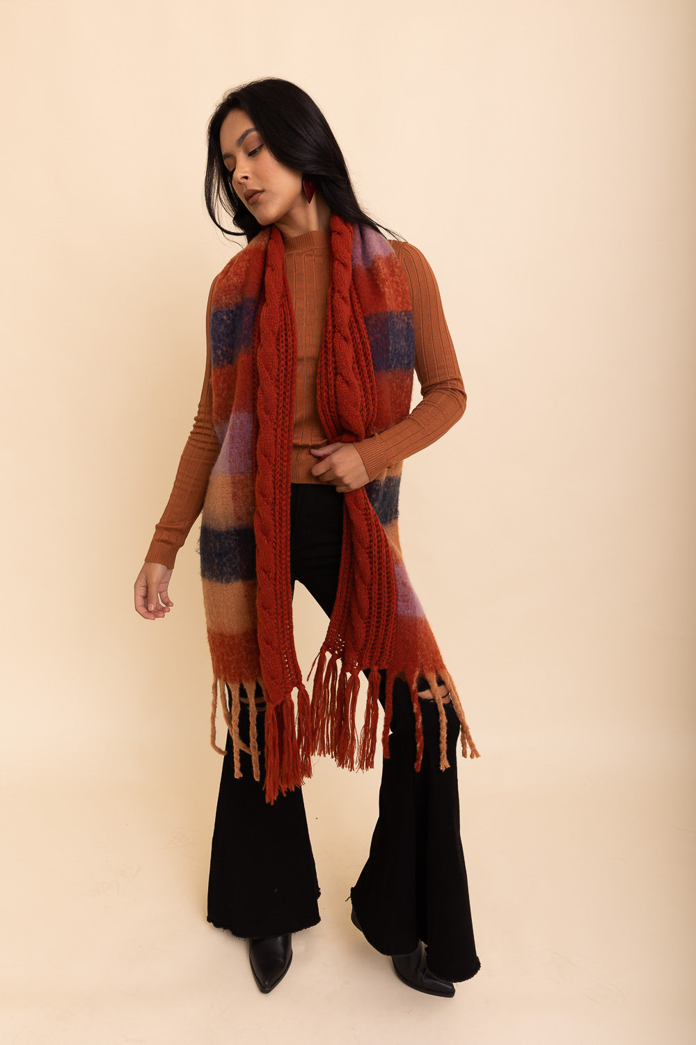 A stylish knit blend scarf with tassel trim, perfect for cold weather outfits, showcasing its soft texture and trendy design.