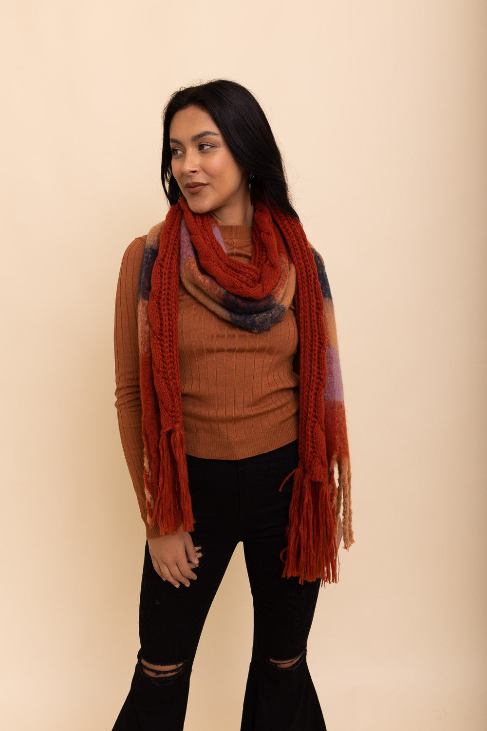 A stylish knit blend scarf with tassel trim, perfect for cold weather outfits, showcasing its soft texture and trendy design.