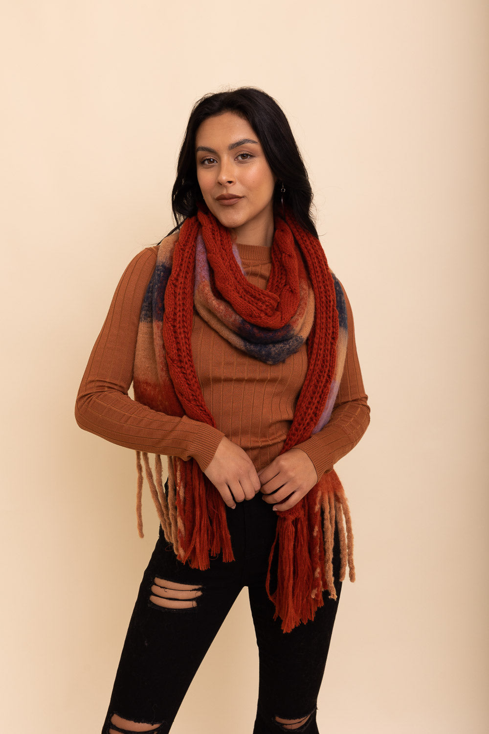 A stylish knit blend scarf with tassel trim, perfect for cold weather outfits, showcasing its soft texture and trendy design.