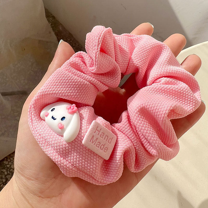 Knock On The Pink Hair Tie featuring a stylish pink and white design, perfect for securing hair in various styles.