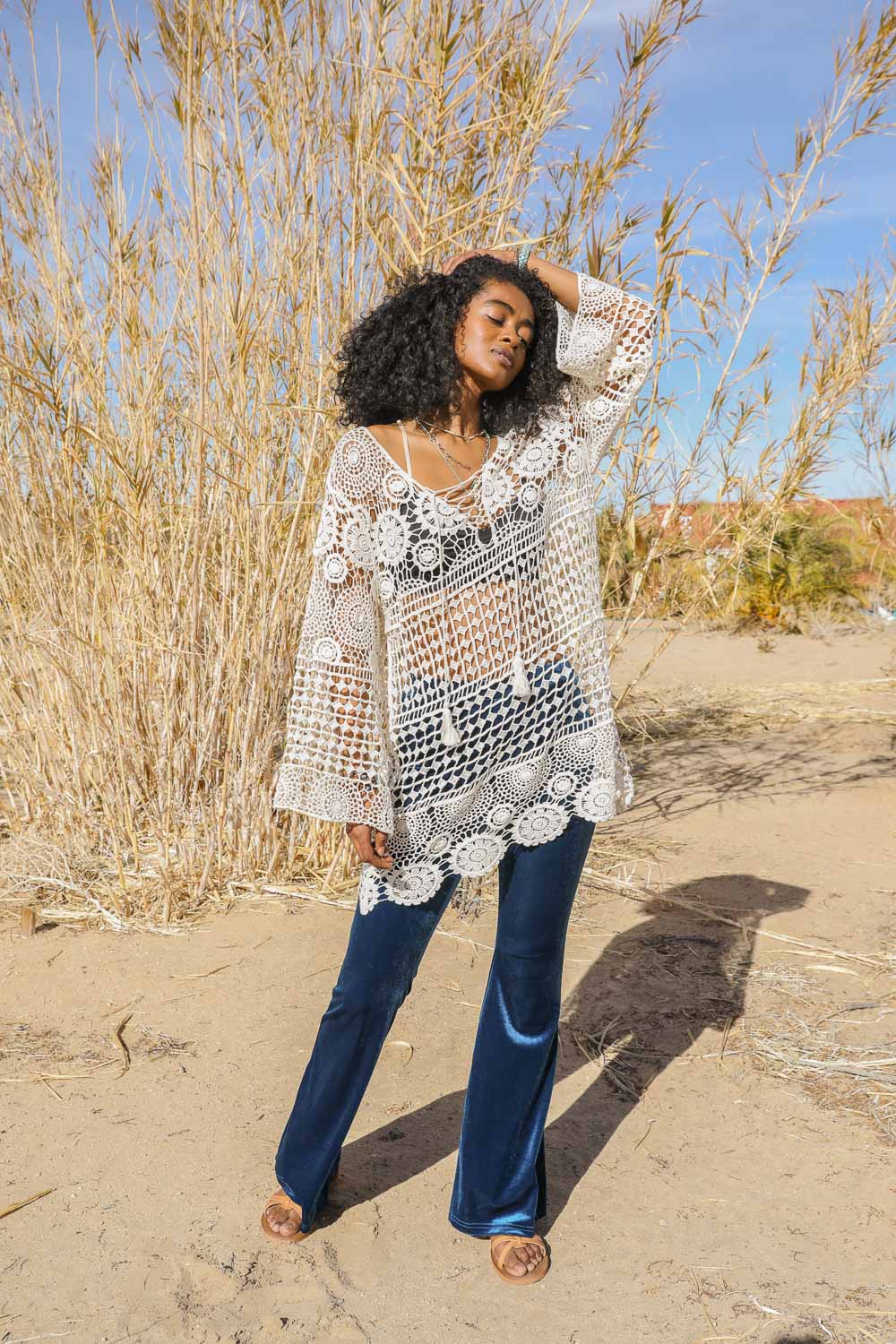 A stylish Lace-Up Crochet Tunic featuring intricate crochet patterns and an adjustable lace-up front, perfect for festivals.