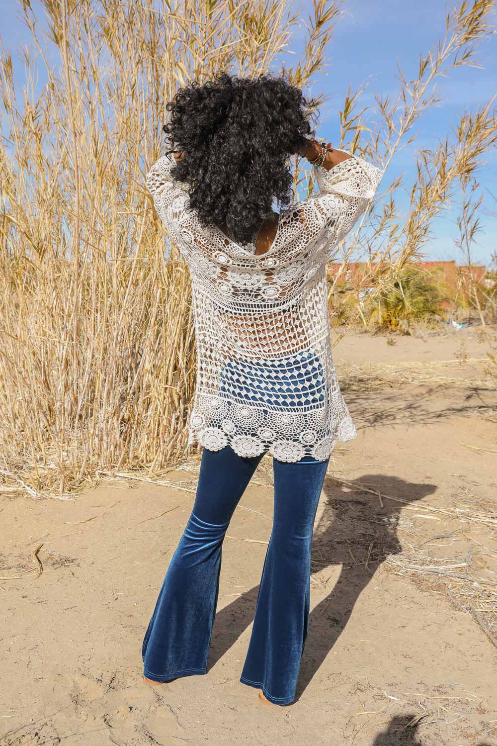 A stylish Lace-Up Crochet Tunic featuring intricate crochet patterns and an adjustable lace-up front, perfect for festivals.