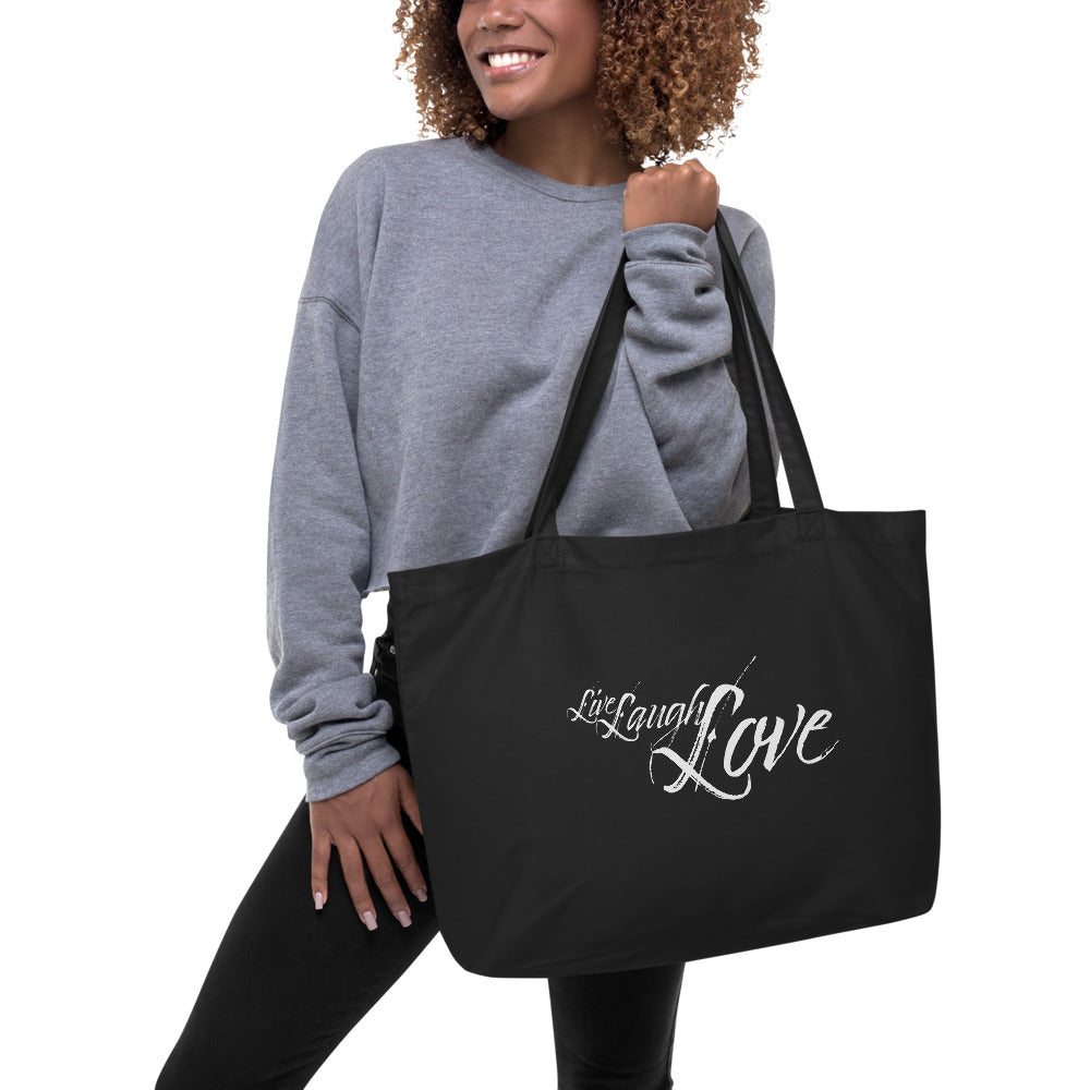 Large black tote bag with 'Live Laugh Love' inspirational print, featuring durable cotton material and long dual straps.