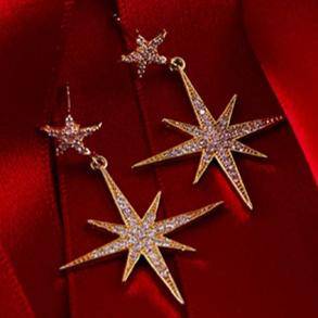 Large silver star burst drop earrings with sparkling cubic zirconia, elegantly designed for a luxurious look.