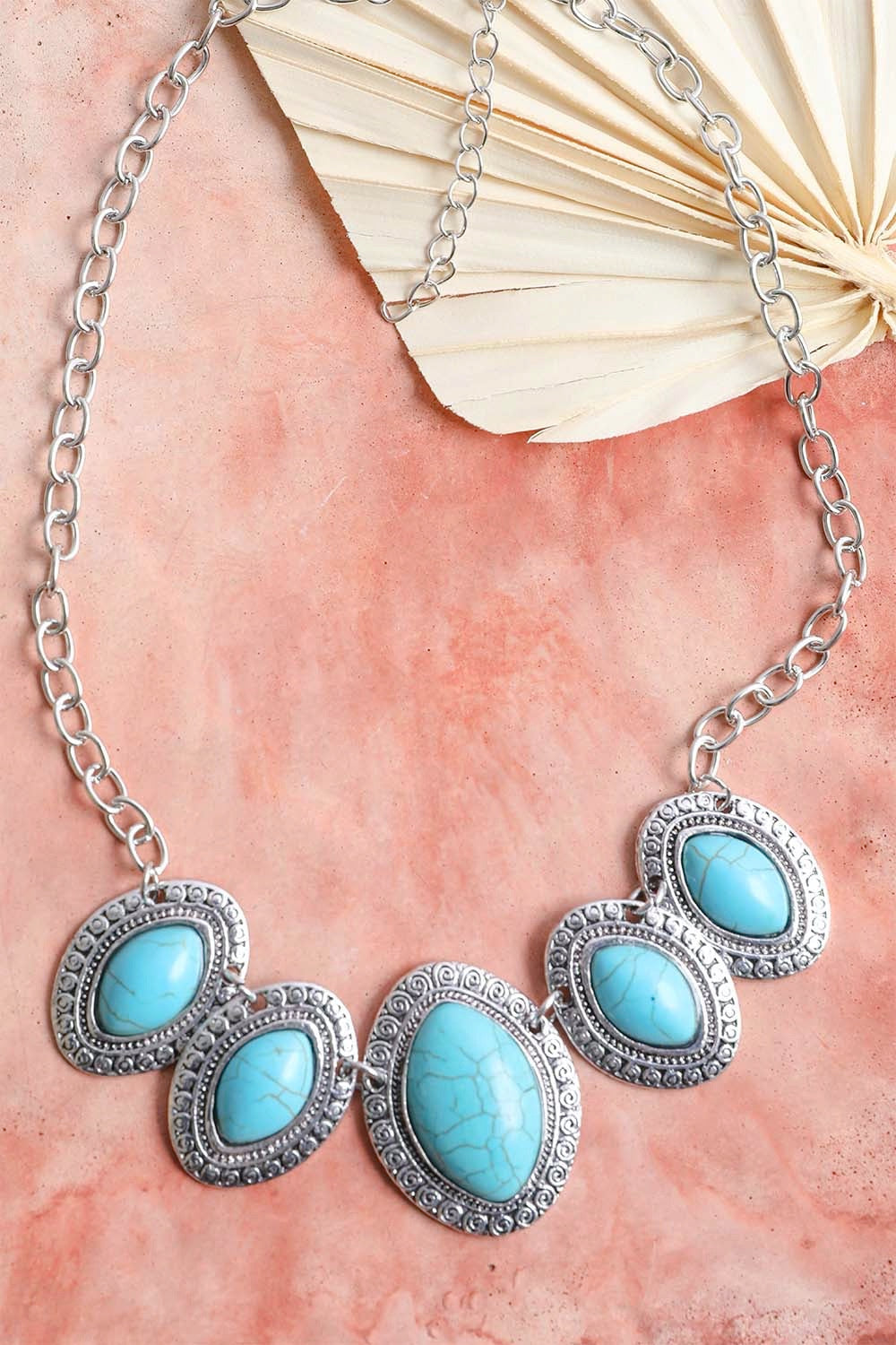 A beautiful Leaflet Turquoise Necklace featuring hand-cut turquoise stones on a zinc alloy chain, perfect for adding color to any outfit.