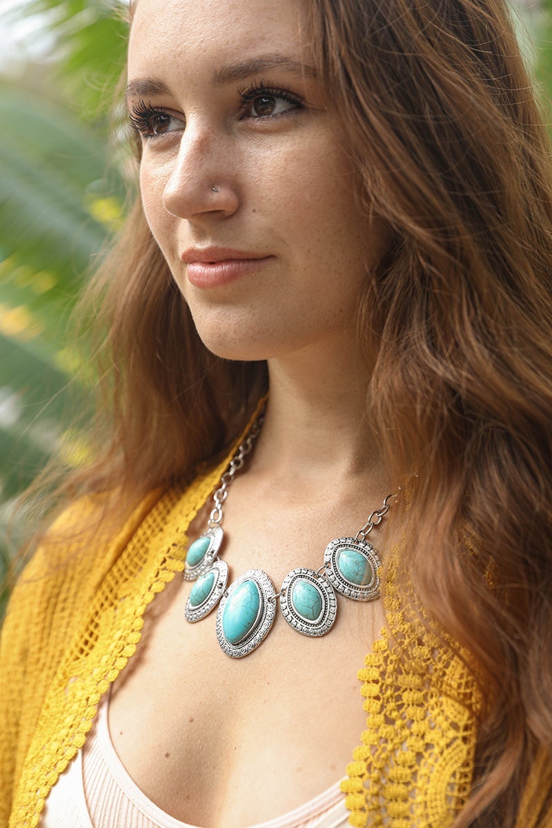 A beautiful Leaflet Turquoise Necklace featuring hand-cut turquoise stones on a zinc alloy chain, perfect for adding color to any outfit.