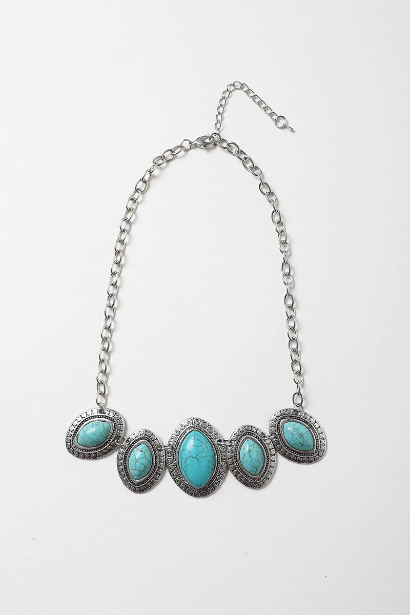 A beautiful Leaflet Turquoise Necklace featuring hand-cut turquoise stones on a zinc alloy chain, perfect for adding color to any outfit.