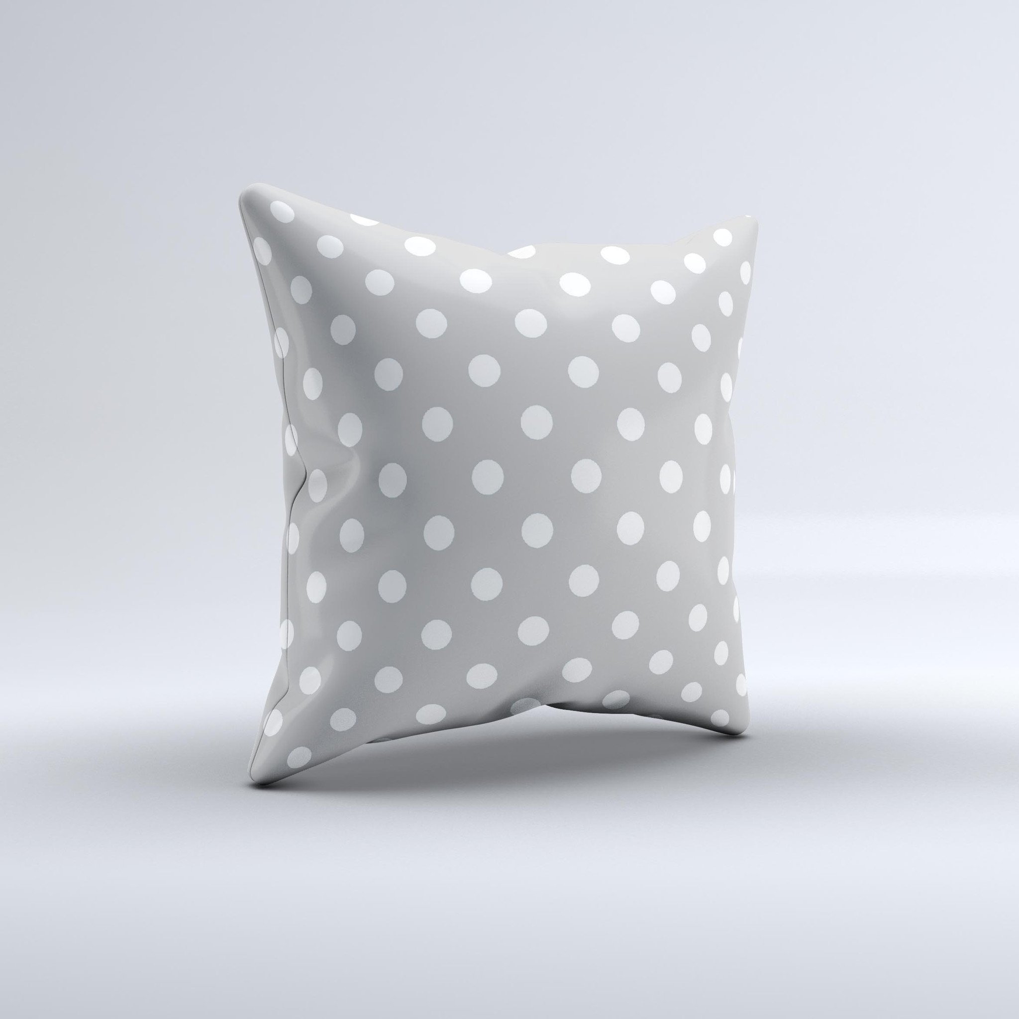 Light gray decorative throw pillow with white polka dots, handcrafted in Virginia, showcasing a unique design and high-quality fabric.