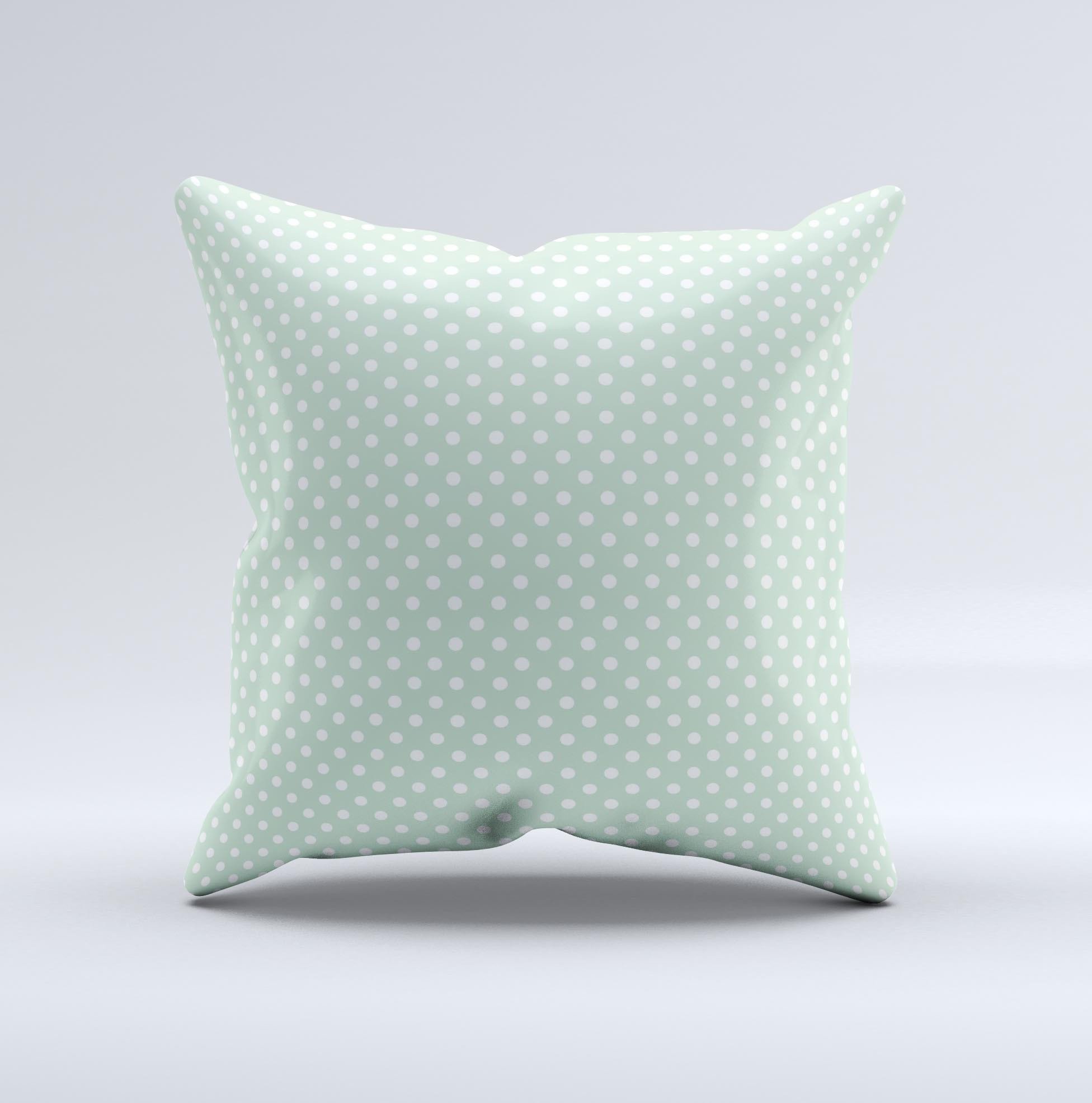 Light green decorative throw pillow with white polkadots, showcasing a unique handcrafted design.