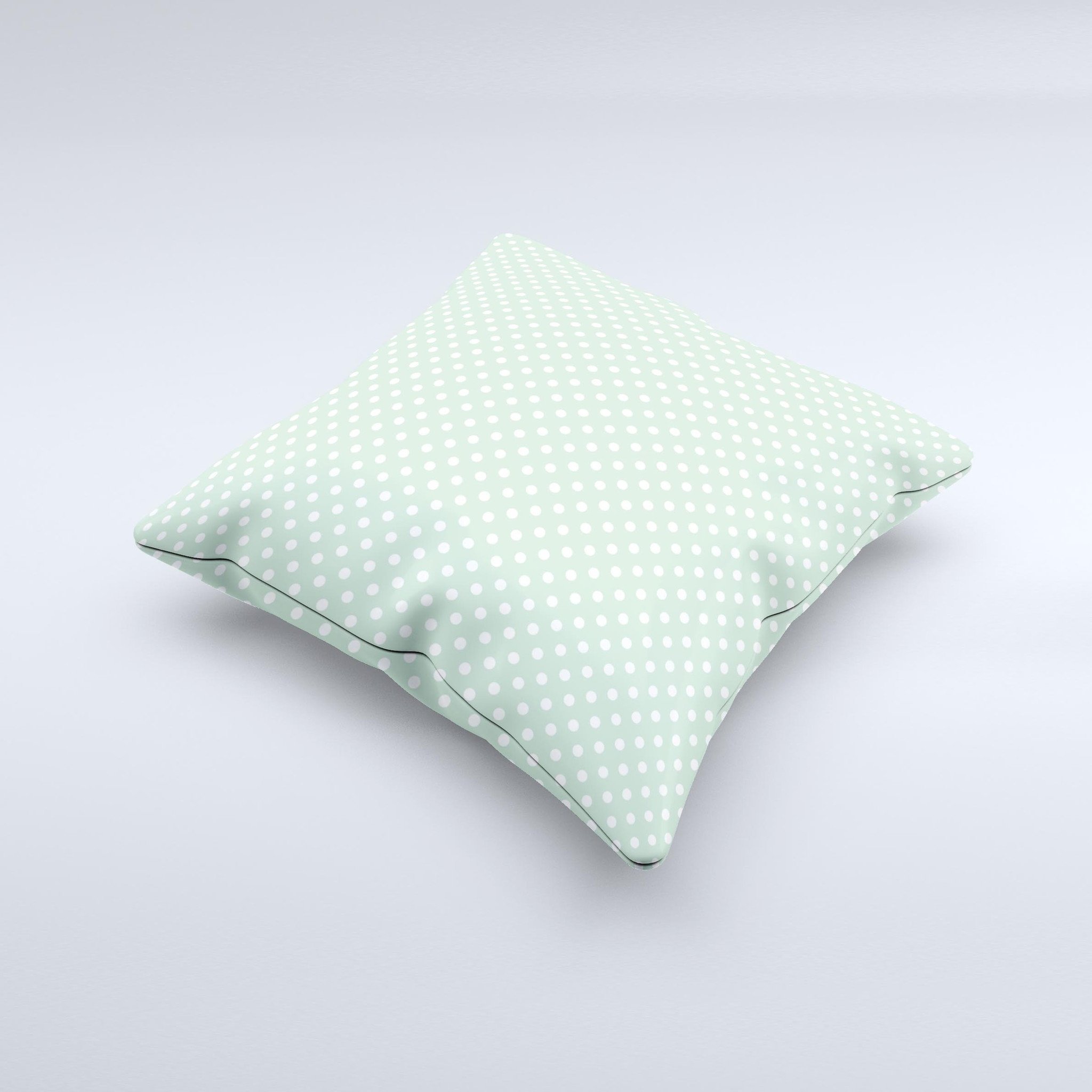 Light green decorative throw pillow with white polkadots, showcasing a unique handcrafted design.