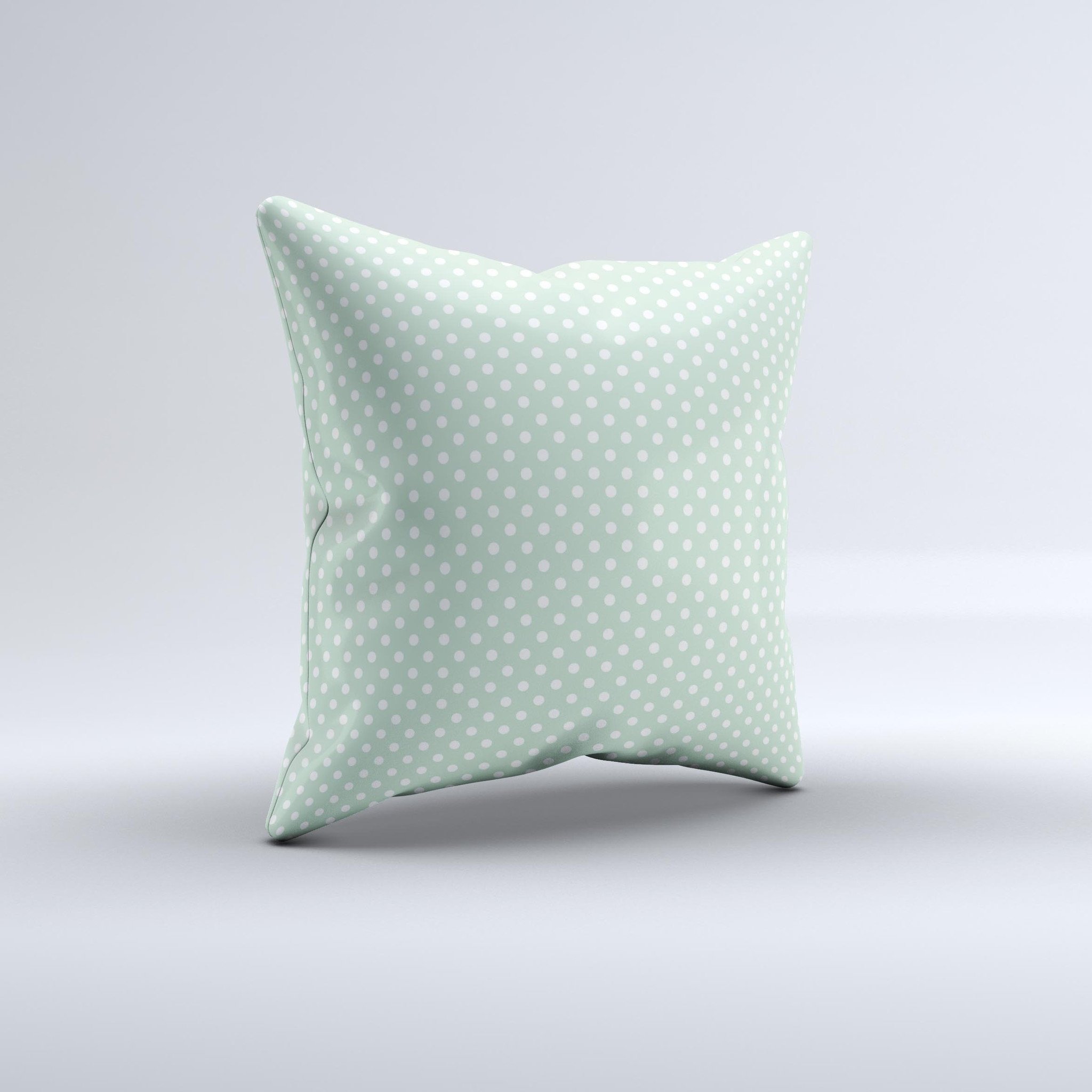 Light green decorative throw pillow with white polkadots, showcasing a unique handcrafted design.