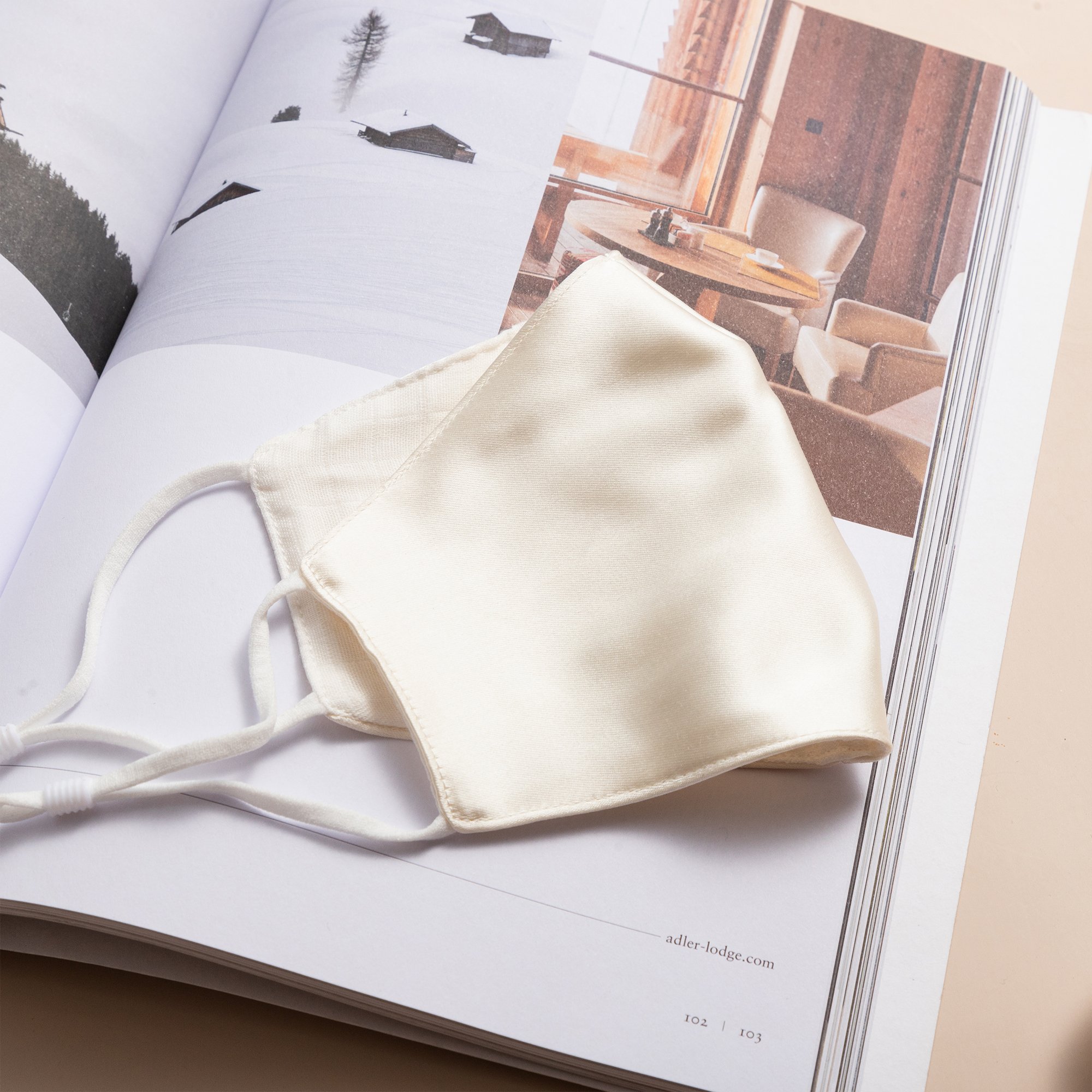 Lily Satin Face Mask featuring adjustable ear loops, soft satin exterior, and a filter pocket for added protection.