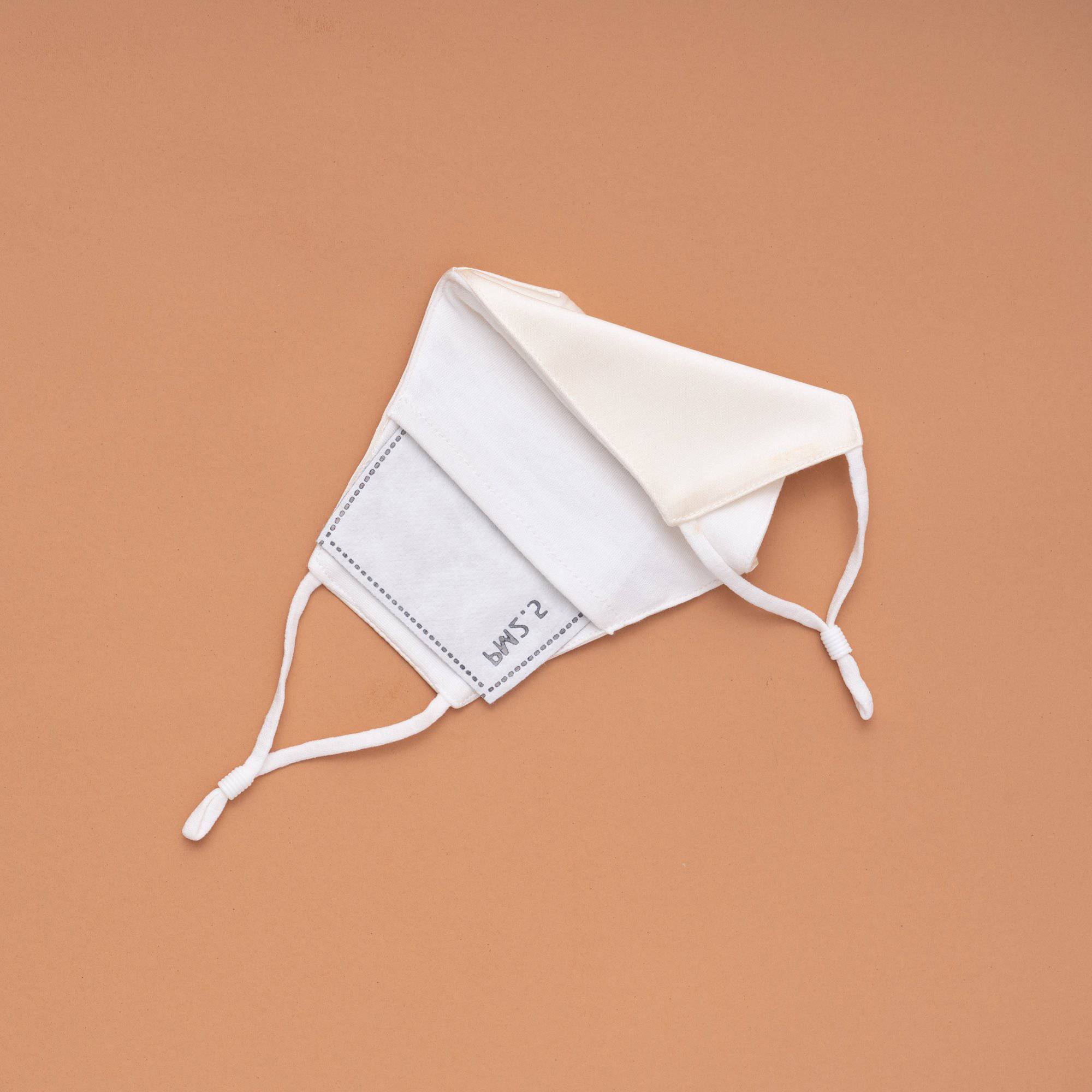 Lily Satin Face Mask featuring adjustable ear loops, soft satin exterior, and a filter pocket for added protection.