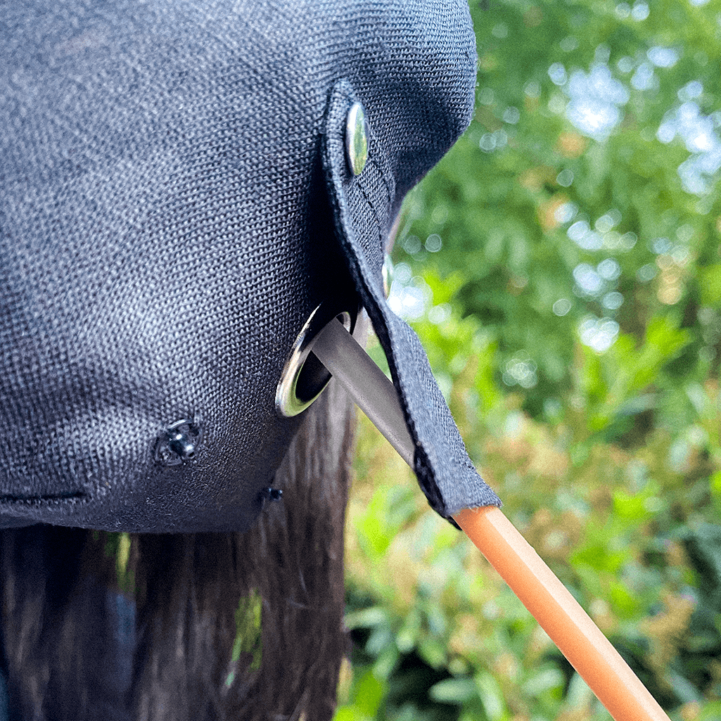 A stylish black face mask made from 100% organic linen, featuring a straw hole for easy sipping, adjustable elastic loops, and a moldable nose bridge.