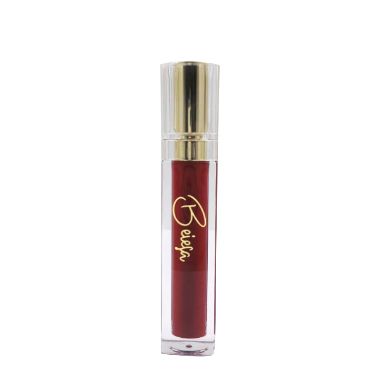 A close-up of the Lip Plumping Serum in Ruby Red, showcasing its glossy texture and vibrant color in a sleek applicator.