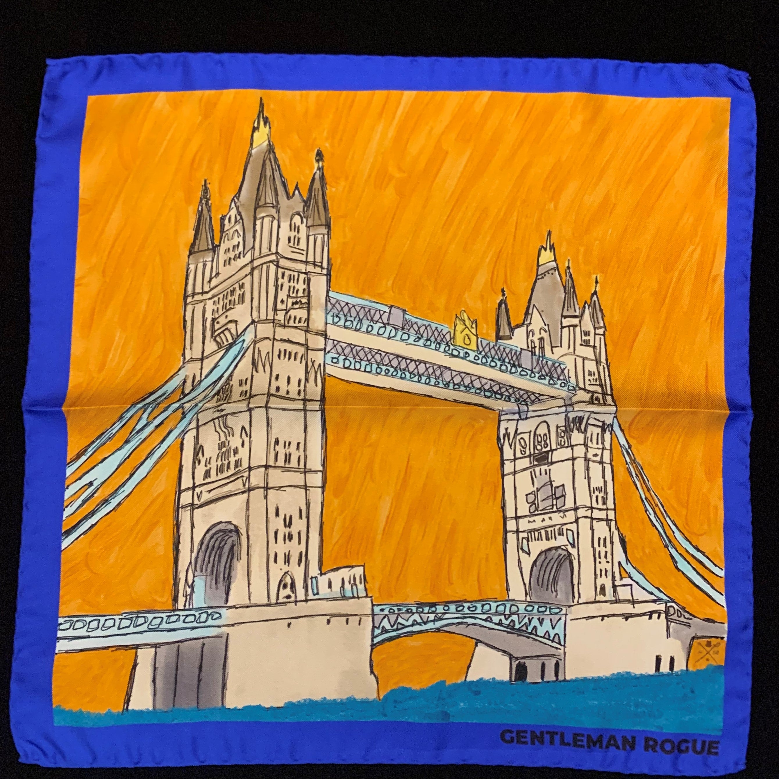 London Tower Bridge Blue Pocket Square featuring hand sketched design in burnt orange and sandstone with a blue border, made from 100% silk.