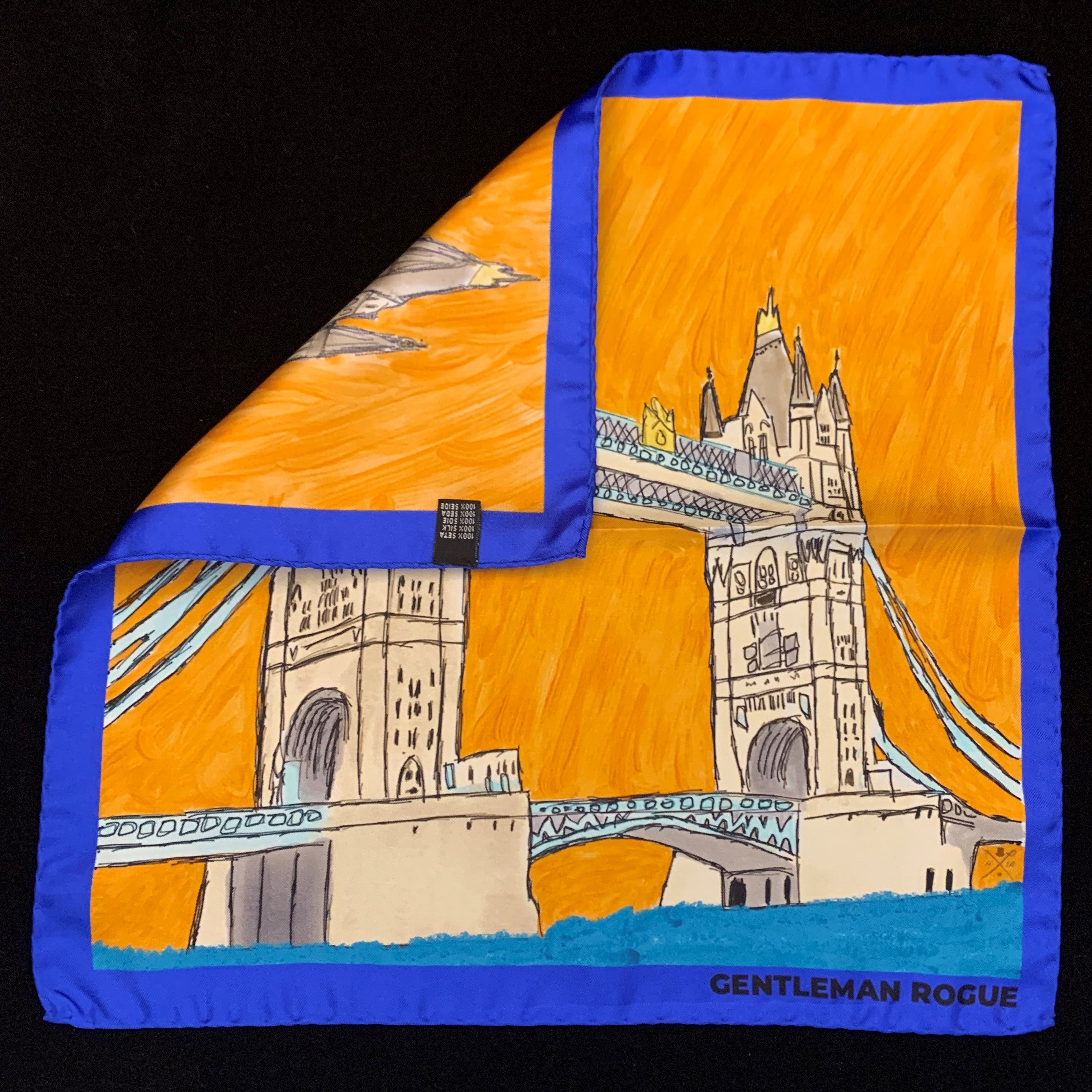 London Tower Bridge Blue Pocket Square featuring hand sketched design in burnt orange and sandstone with a blue border, made from 100% silk.