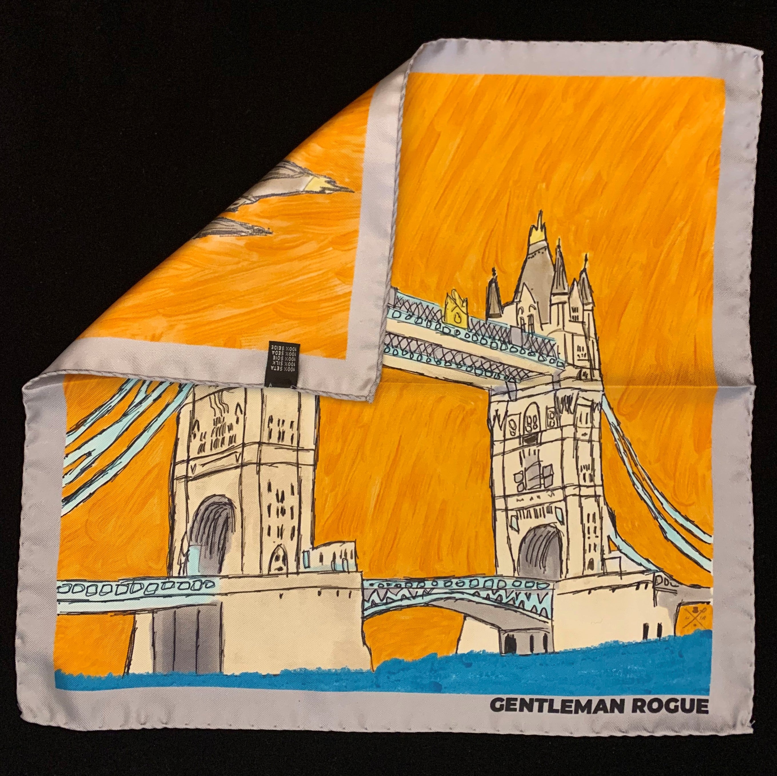 London Tower Bridge Silver Pocket Square featuring hand sketched design in burnt orange and sandstone with a silver border.