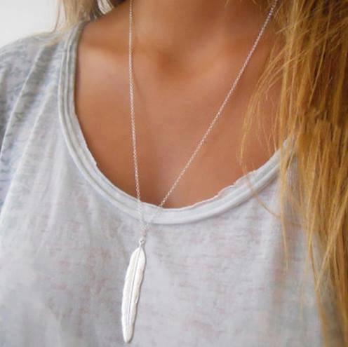 A long feather necklace featuring a delicate chain and a beautifully crafted feather pendant, available in gold and silver finishes.