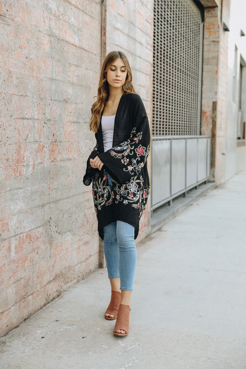 A stylish Long Floral Kimono Cardigan featuring a vibrant floral print, perfect for warm weather outings.