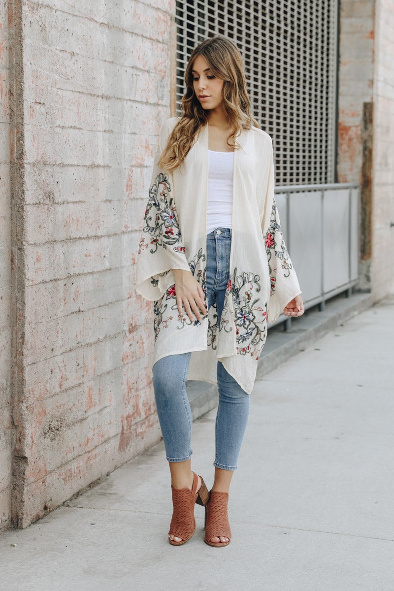 A stylish Long Floral Kimono Cardigan featuring a vibrant floral print, perfect for warm weather outings.