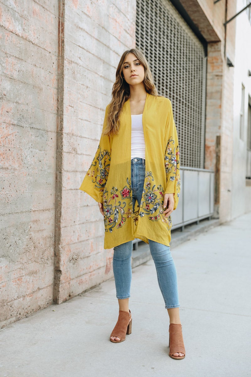 A stylish Long Floral Kimono Cardigan featuring a vibrant floral print, perfect for warm weather outings.