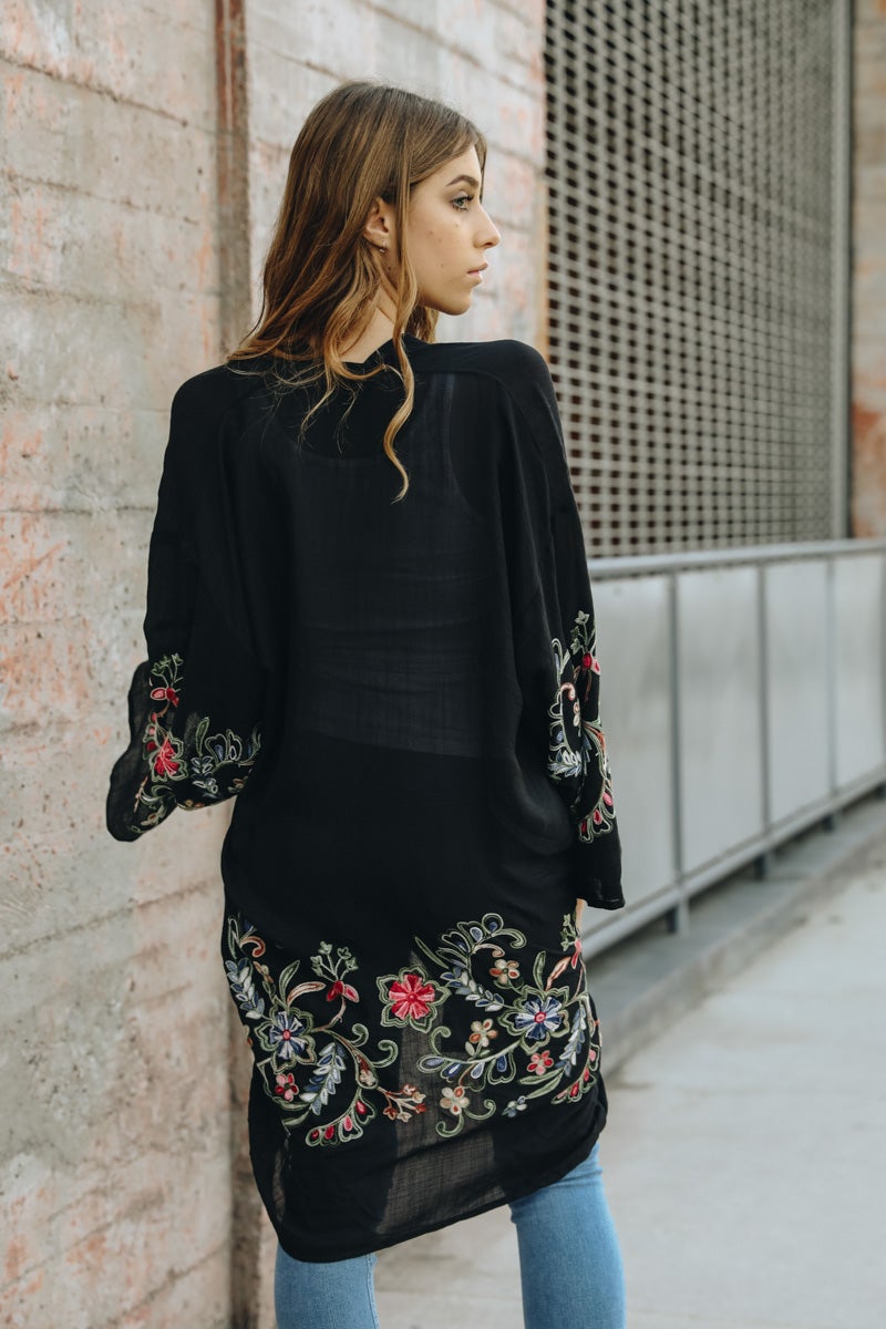 A stylish Long Floral Kimono Cardigan featuring a vibrant floral print, perfect for warm weather outings.