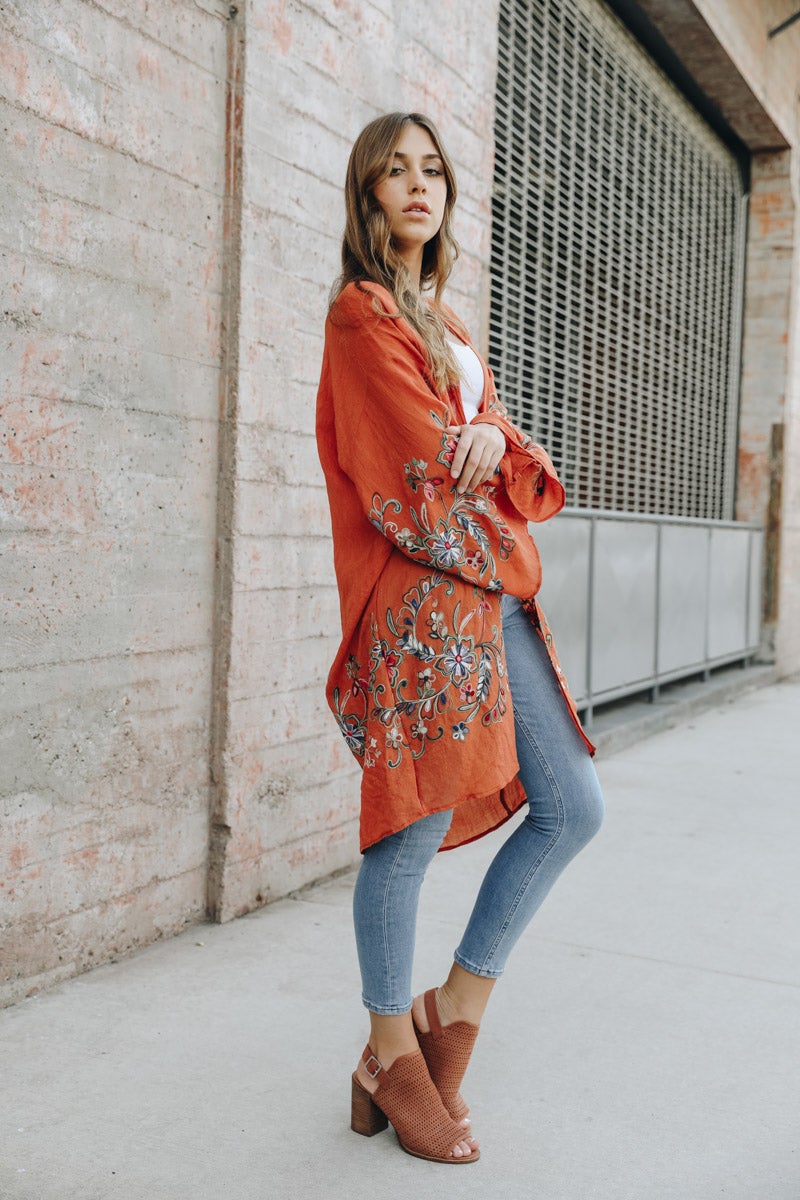 A stylish Long Floral Kimono Cardigan featuring a vibrant floral print, perfect for warm weather outings.