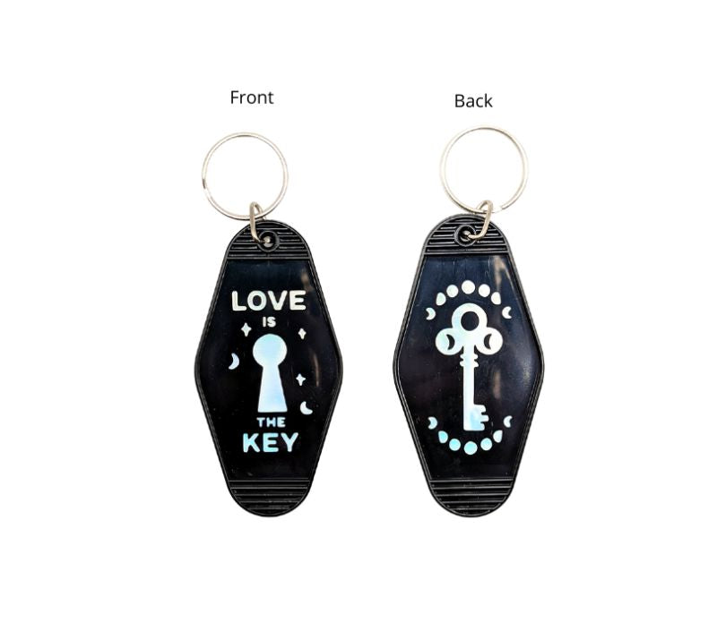 A vibrant Luminous Light Keychain featuring a retro design with the mantra 'Love is the Key', made from recycled plastic.