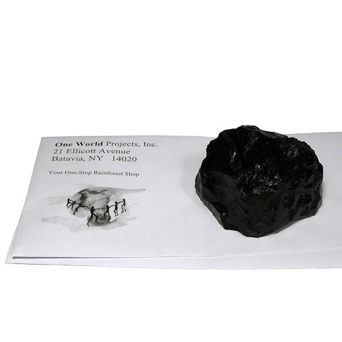 A handmade Lump of Coal Paperweight crafted by artisans from the Morca Coal Project in Colombia, showcasing its unique black sedimentary rock design.