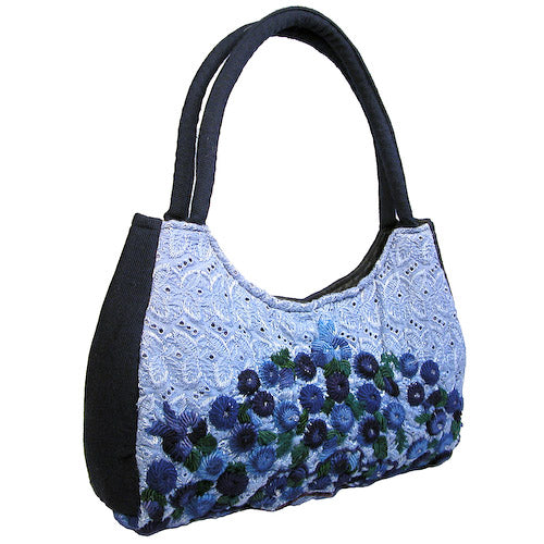 Luna Rococo Handbag made from recycled Huipils, showcasing vibrant colors and intricate designs, perfect for everyday use.