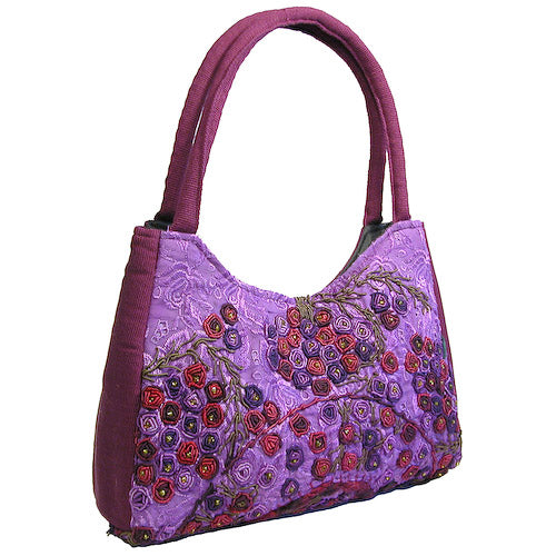 Luna Rococo Handbag made from recycled Huipils, showcasing vibrant colors and intricate designs, perfect for everyday use.