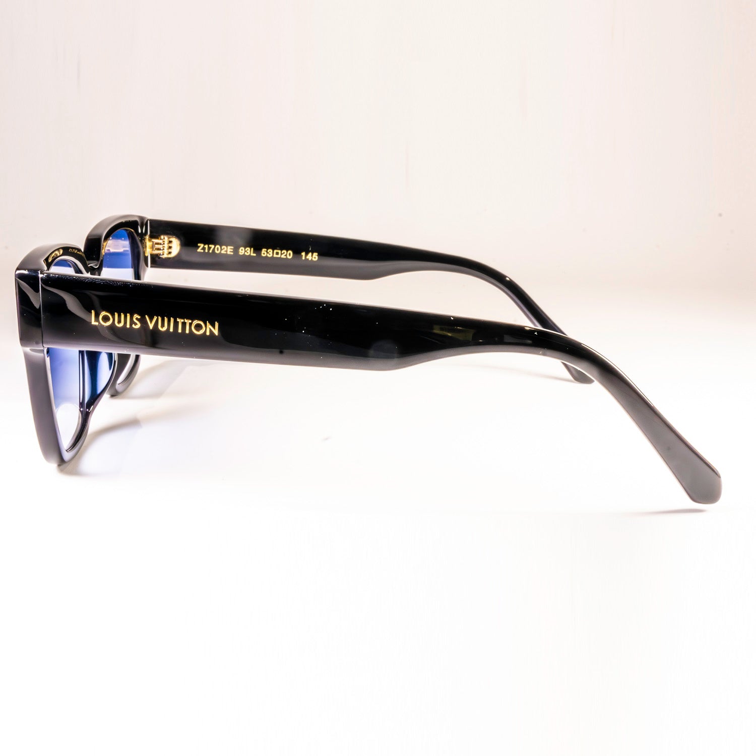 Stylish LV Street Sunglasses featuring a black acetate frame, black lenses, and gold-colour hardware with iconic Louis Vuitton design elements.