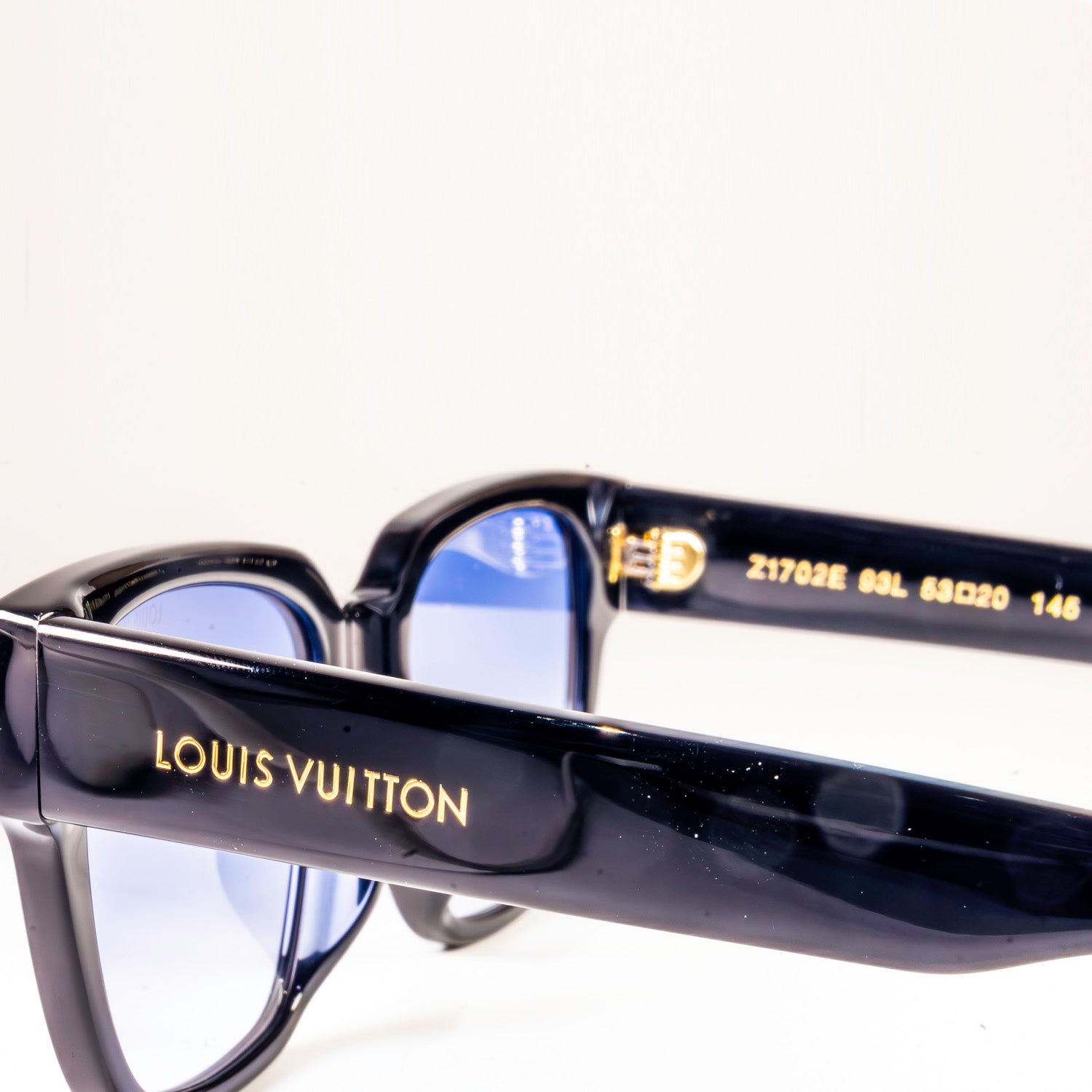 Stylish LV Street Sunglasses featuring a black acetate frame, black lenses, and gold-colour hardware with iconic Louis Vuitton design elements.