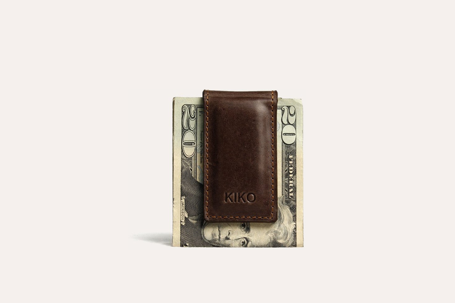 A stylish Magnetic Money Clip made from premium cowhide leather, featuring a compact design and heat burnished details.