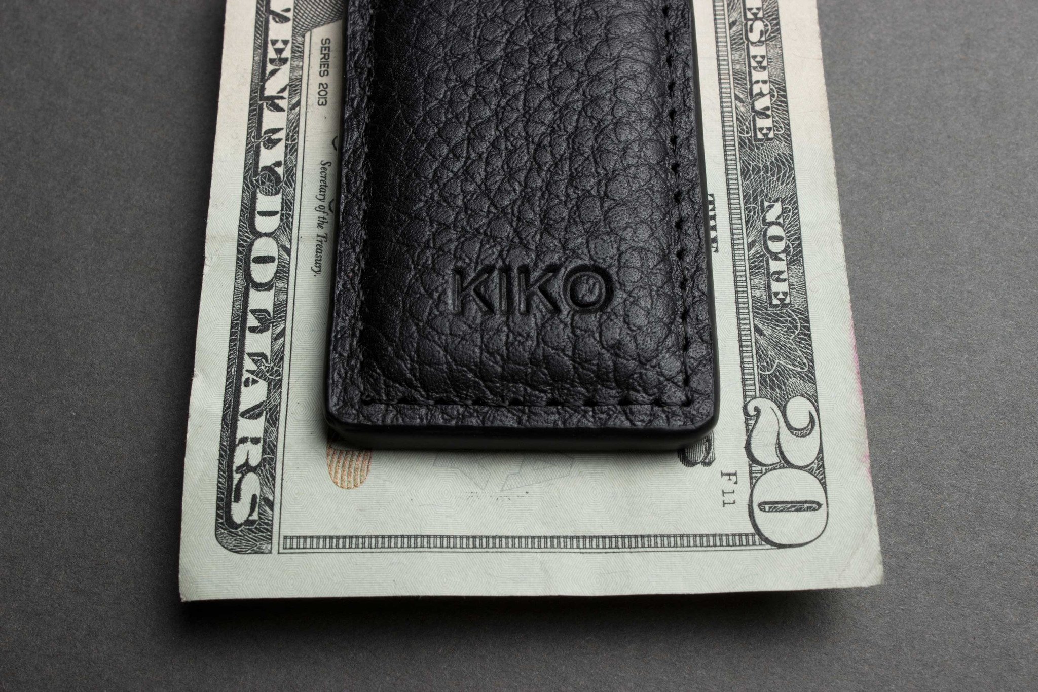 A stylish Magnetic Money Clip made from premium cowhide leather, featuring a compact design and heat burnished details.