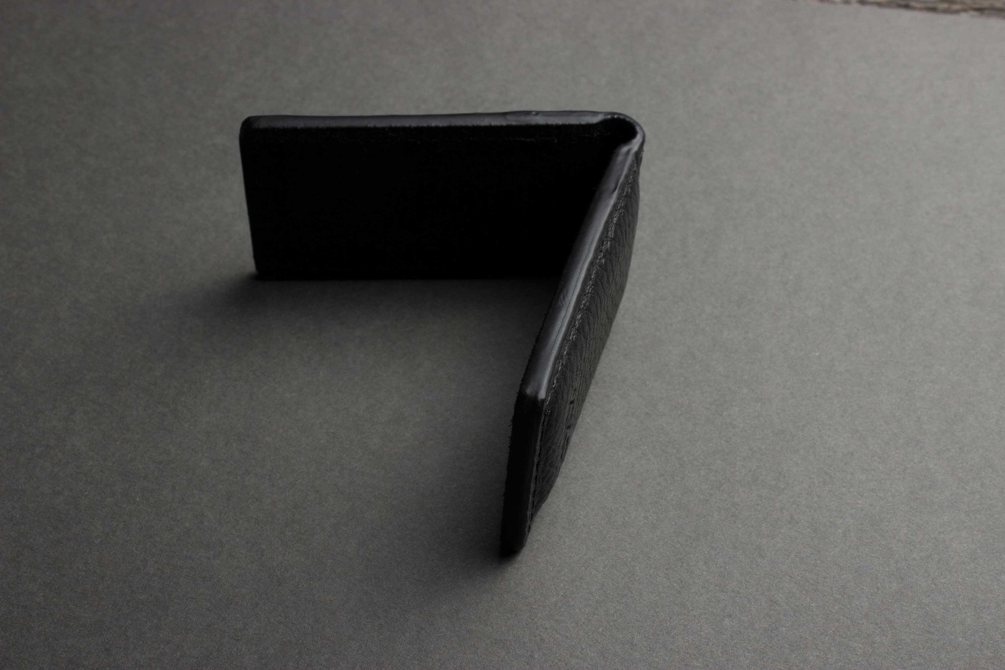 A stylish Magnetic Money Clip made from premium cowhide leather, featuring a compact design and heat burnished details.