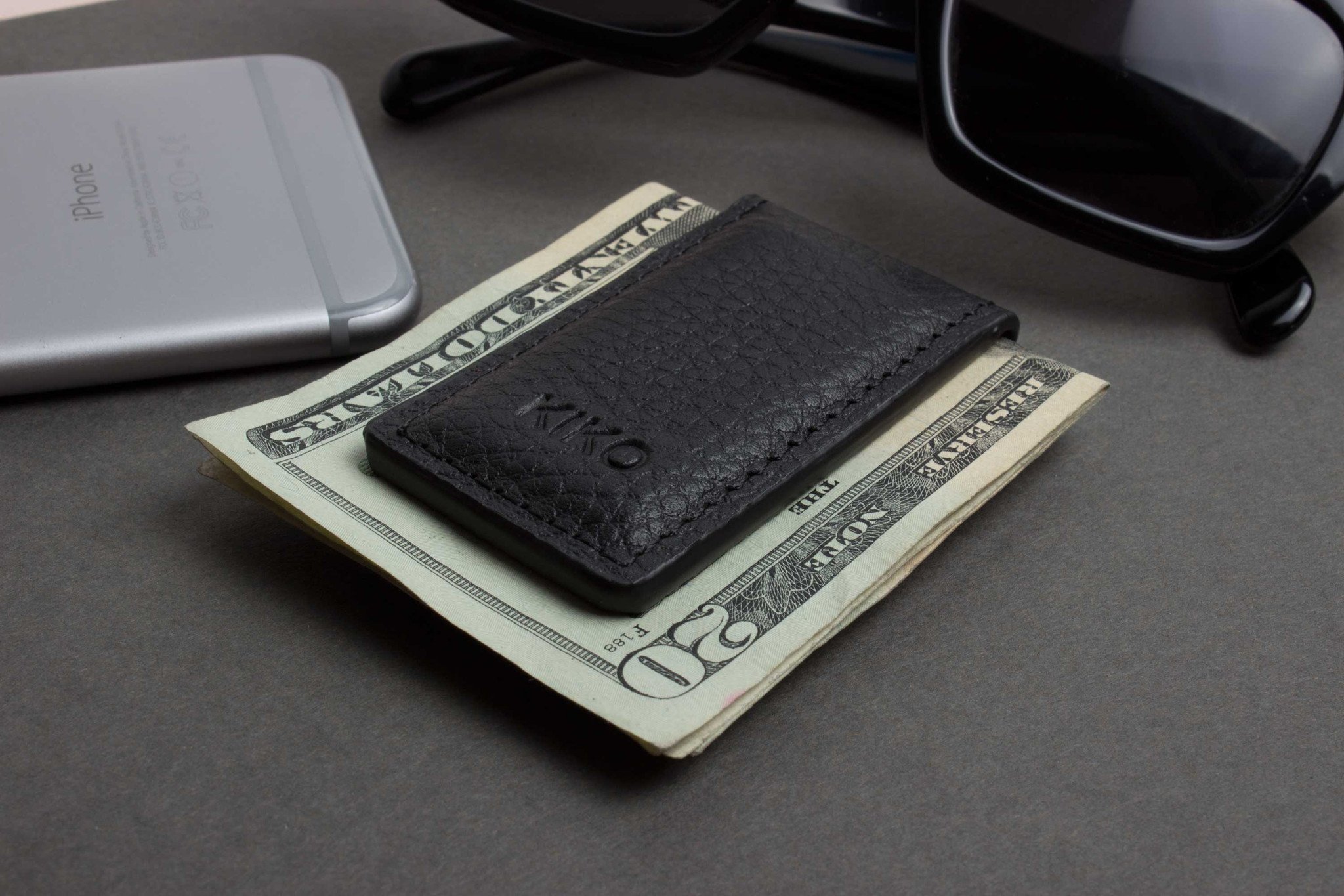 A stylish Magnetic Money Clip made from premium cowhide leather, featuring a compact design and heat burnished details.