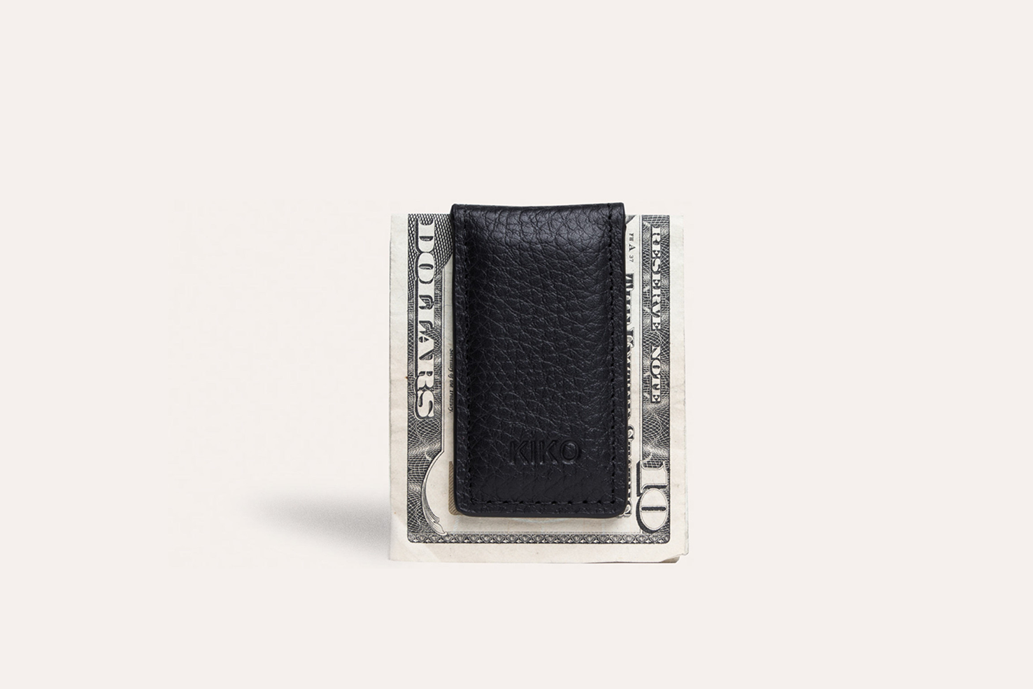 A stylish Magnetic Money Clip made from premium cowhide leather, featuring a compact design and heat burnished details.