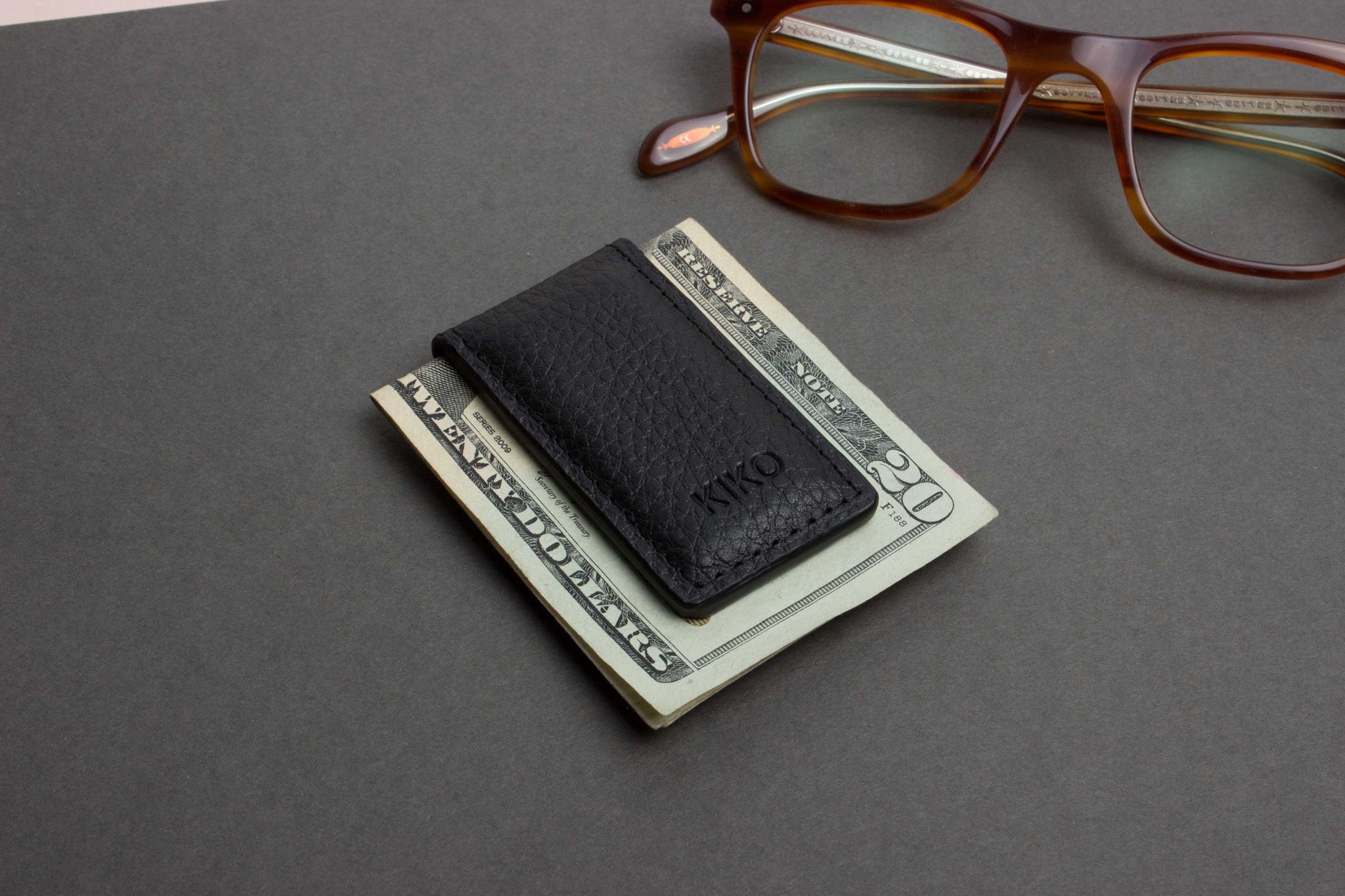 A stylish Magnetic Money Clip made from premium cowhide leather, featuring a compact design and heat burnished details.