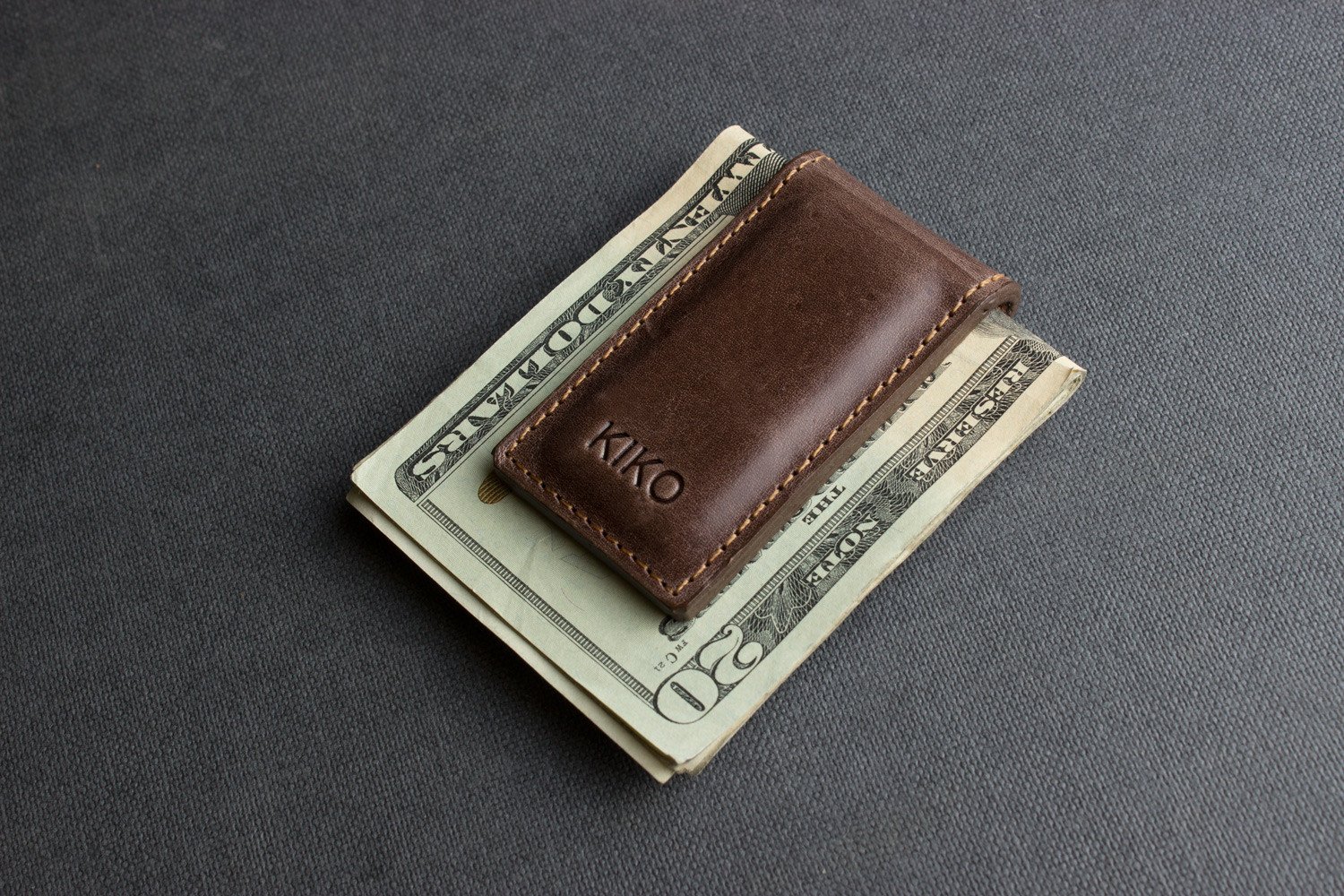 A stylish Magnetic Money Clip made from premium cowhide leather, featuring a compact design and heat burnished details.