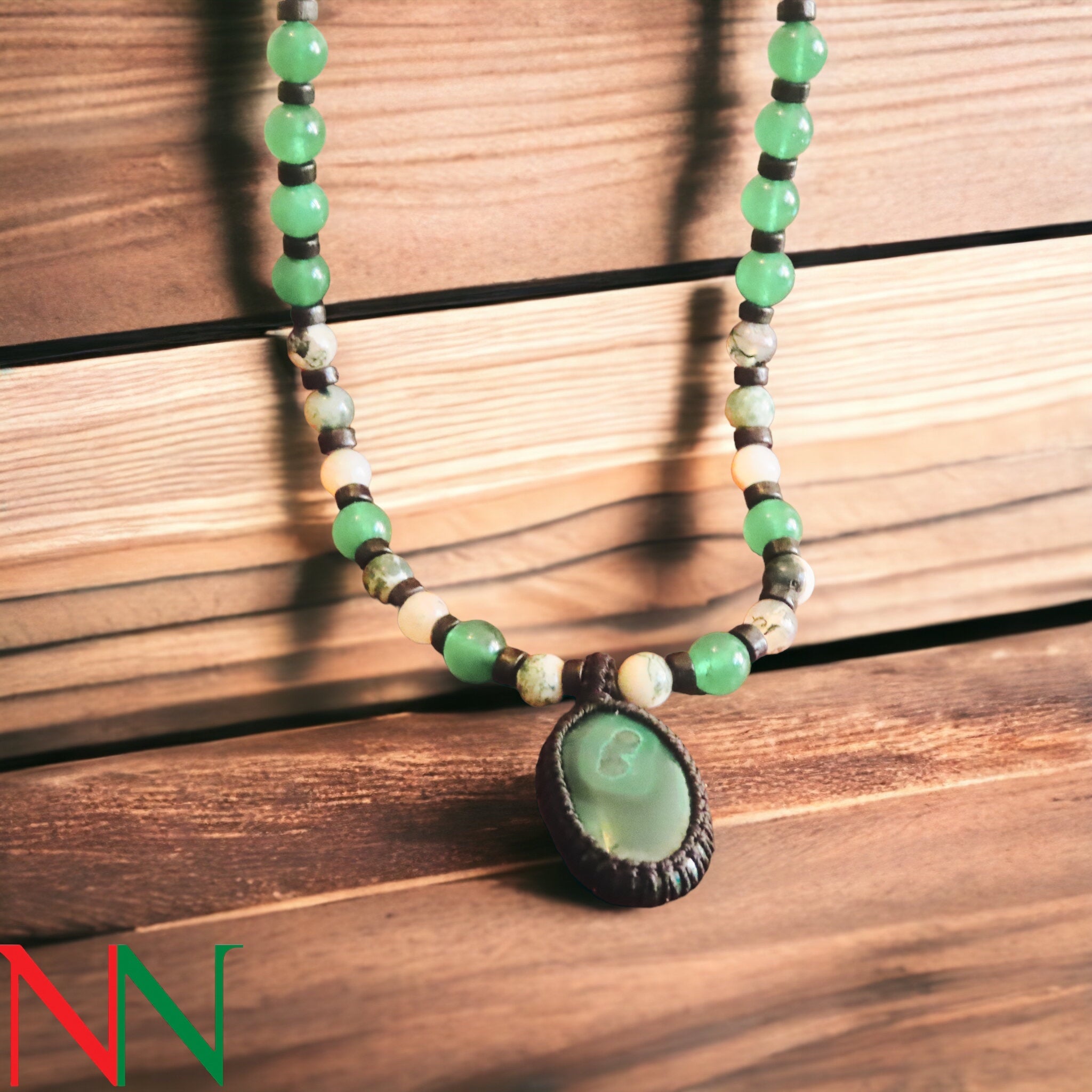 A stunning malachite necklace featuring vibrant green hues and unique banding, symbolizing peace and ancient Egyptian culture.