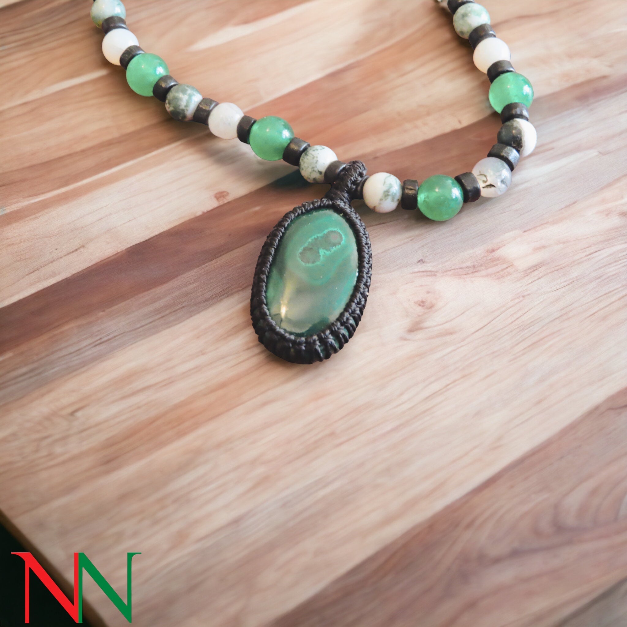 A stunning malachite necklace featuring vibrant green hues and unique banding, symbolizing peace and ancient Egyptian culture.