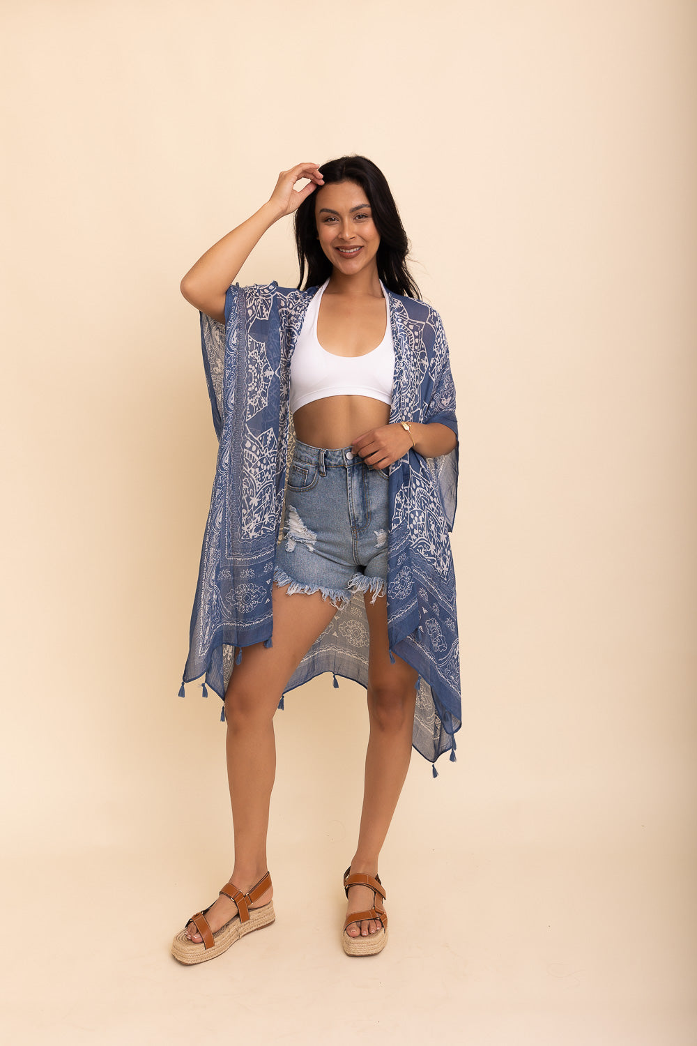 A stylish Mandala Tassel Kimono featuring vibrant mandala patterns and playful tassels, perfect for beach outings.