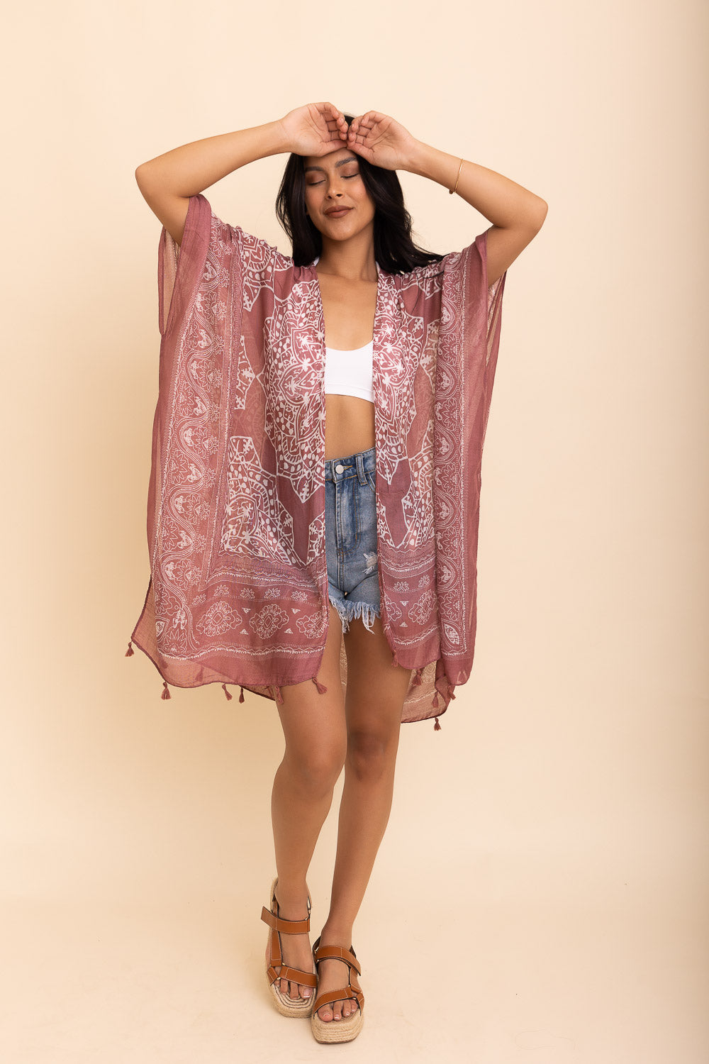 A stylish Mandala Tassel Kimono featuring vibrant mandala patterns and playful tassels, perfect for beach outings.