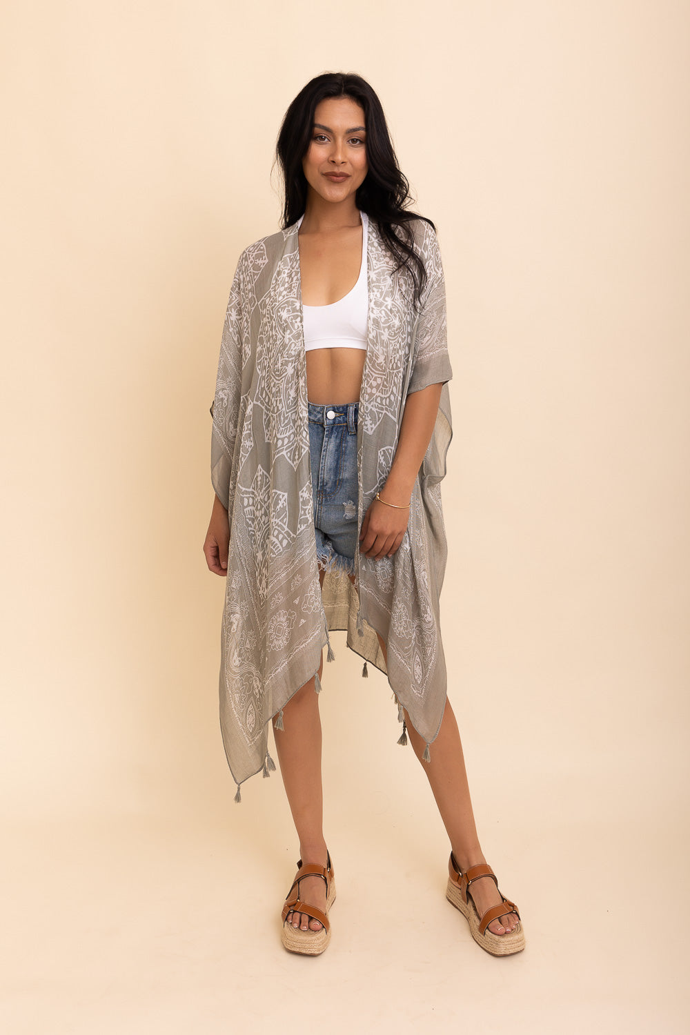 A stylish Mandala Tassel Kimono featuring vibrant mandala patterns and playful tassels, perfect for beach outings.