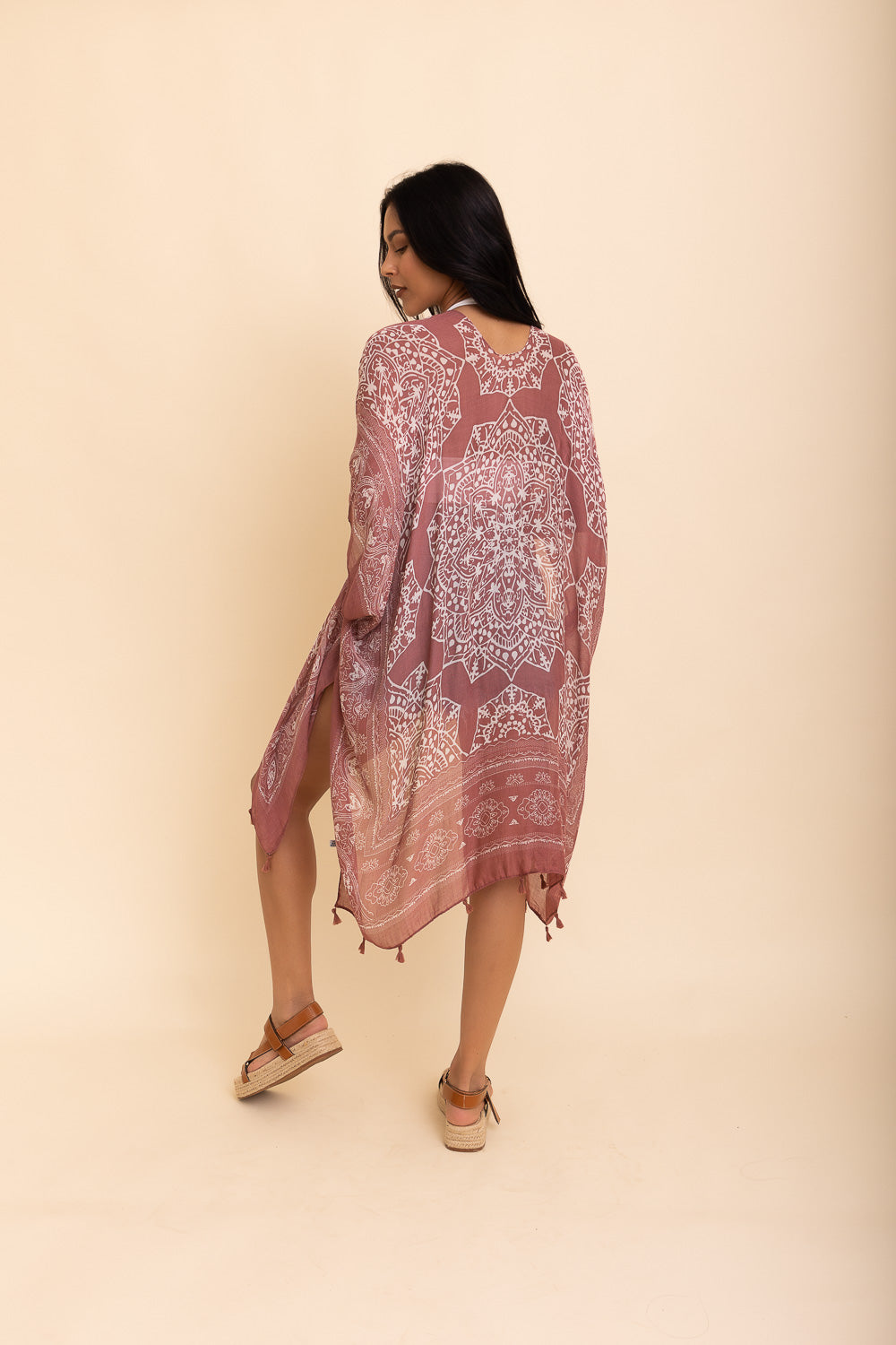 A stylish Mandala Tassel Kimono featuring vibrant mandala patterns and playful tassels, perfect for beach outings.