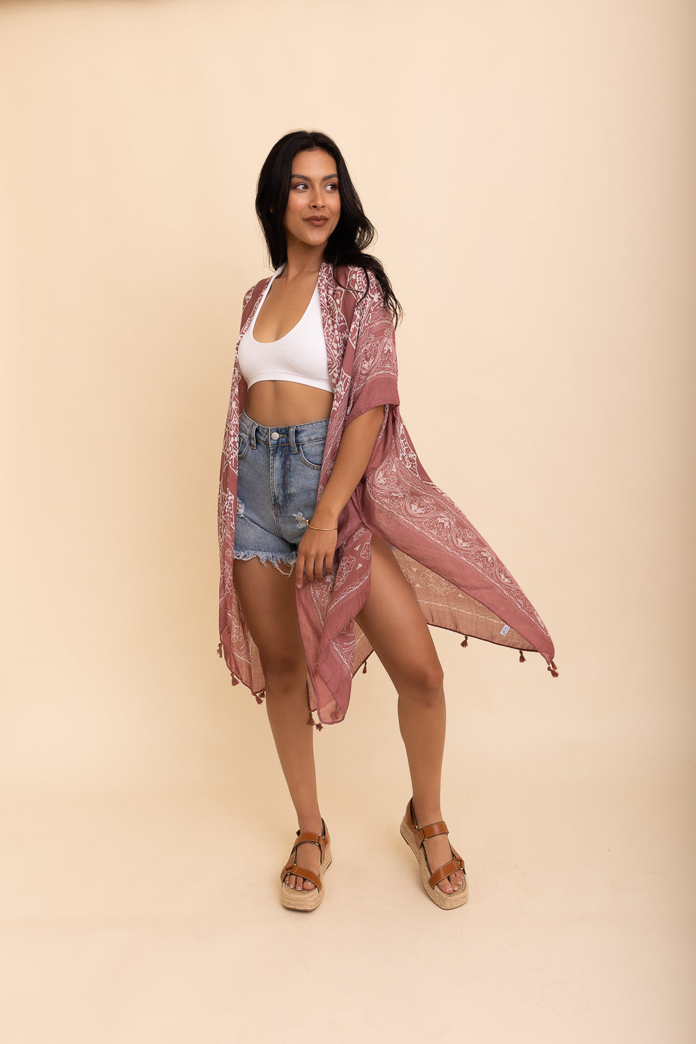 A stylish Mandala Tassel Kimono featuring vibrant mandala patterns and playful tassels, perfect for beach outings.